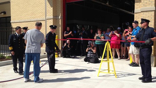 Pvt. Steve Stainbrook cuts a metal bar with the Jaws of Life -- TFD's version of a ribbon-cutting -- at the rededication ceremony for Station No. 3 in North Toledo on June 16. Toledo Free Press photo by Sarah Ottney