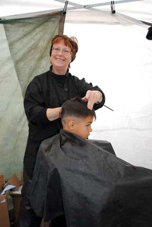 Hairstylist Lavonne Kujawa gives a free haircut, one of Tent City's most popular services (Photo by Dawn Hall)