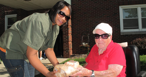 The Area Office on Aging of Northwestern Ohio helps provide delivered meals for seniors like Evelyn Sullivan, right, who is blind. Photo courtesy Area Office on Aging of Northwestern Ohio.