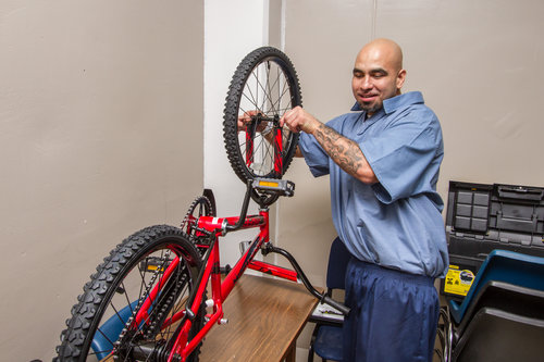 Joe Luna, an inmate at Toledo Correctional Institution, helps assemble bicycles Dec. 5 for Lucas County Children Services and other Northwest Ohio counties. Toledo Free Press Photos by Christie Materni